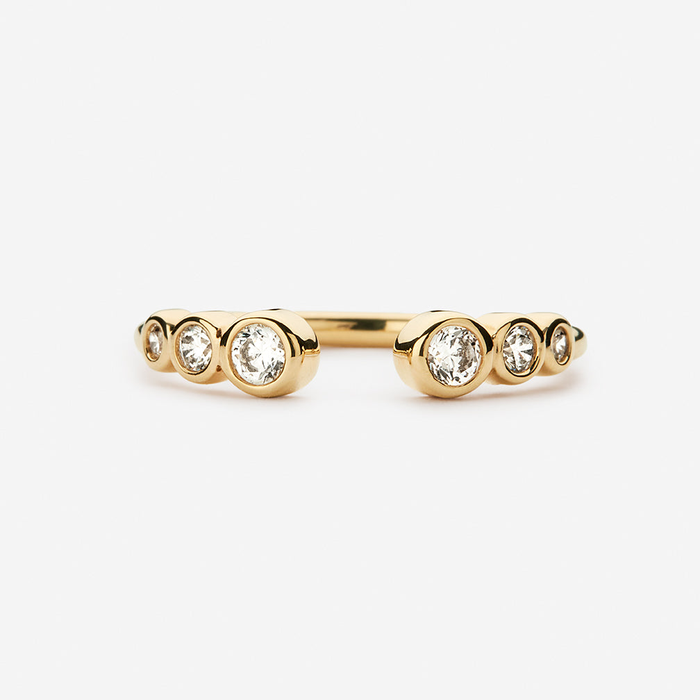 Gold hoop earrings with clear crystal stones, pavé-style bezel